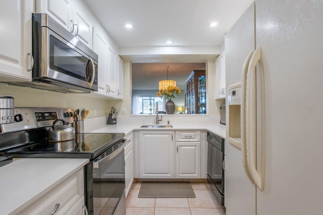 kitchen with sink, white cabinetry, stainless steel appliances, and light tile patterned floors