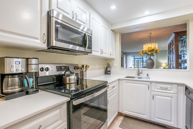 kitchen with sink, white cabinets, and stainless steel appliances