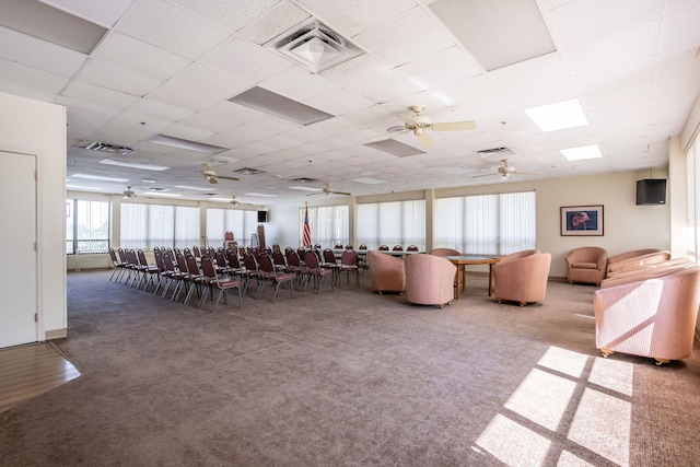 interior space featuring carpet and a paneled ceiling