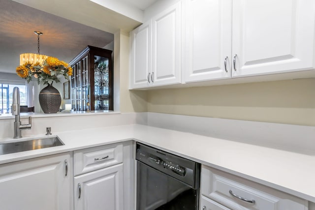 kitchen featuring dishwasher, white cabinets, sink, hanging light fixtures, and a chandelier