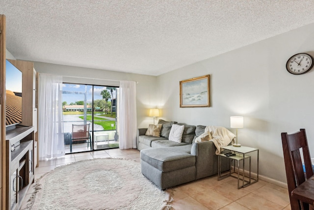 tiled living room featuring a textured ceiling