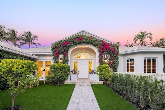 entrance to property with a lawn