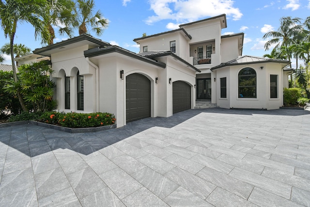 mediterranean / spanish-style house with a balcony and a garage