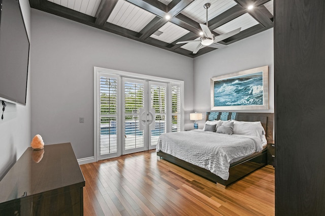 bedroom featuring access to outside, french doors, ceiling fan, beam ceiling, and wood-type flooring