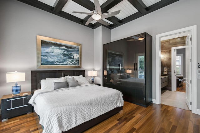 bedroom with beam ceiling, ceiling fan, and dark wood-type flooring