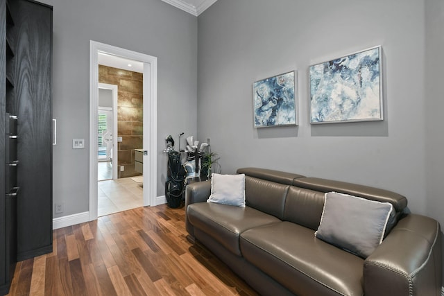 living room with wood-type flooring and crown molding