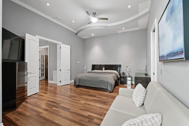 bedroom with ceiling fan, crown molding, and hardwood / wood-style flooring