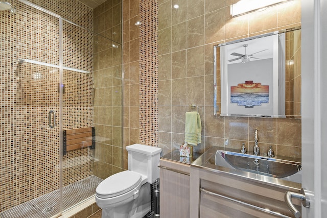 bathroom featuring an enclosed shower, toilet, decorative backsplash, vanity, and tile walls