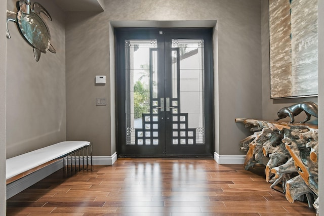 foyer entrance with wood-type flooring and french doors