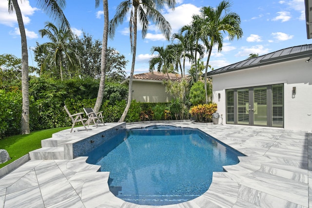 view of swimming pool with a patio