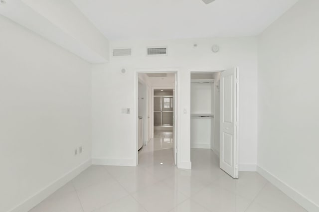 unfurnished bedroom featuring a closet and light tile patterned floors