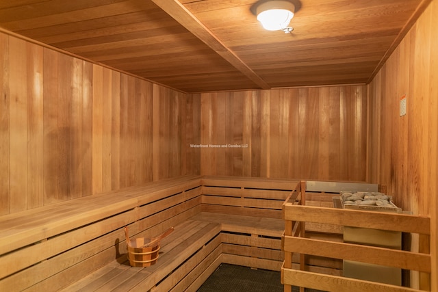 view of sauna / steam room with wood ceiling and wood walls