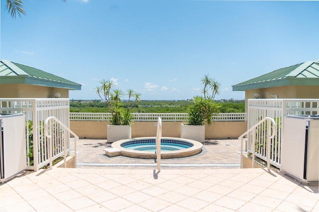 view of patio featuring an in ground hot tub