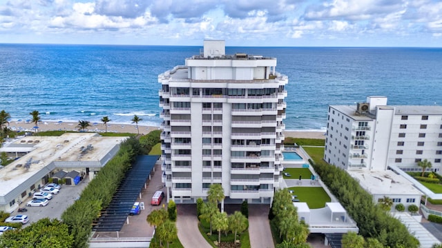 drone / aerial view with a water view and a view of the beach