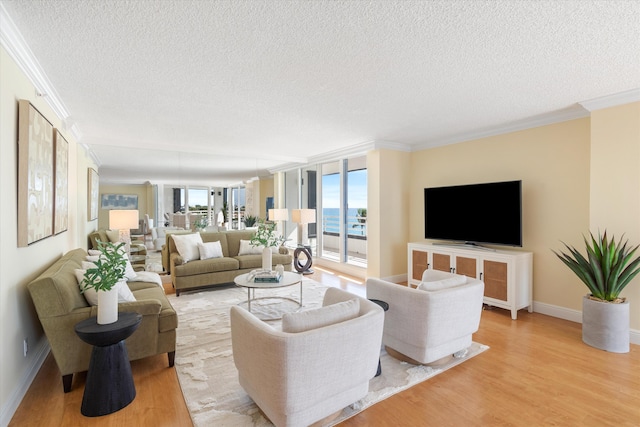 living room with ornamental molding, light wood-type flooring, and a textured ceiling