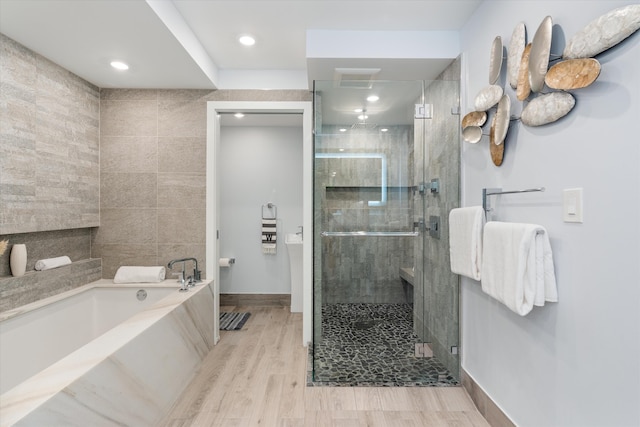 bathroom with plus walk in shower and wood-type flooring