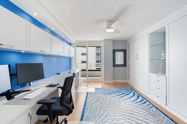 office area featuring ceiling fan, a textured ceiling, and light wood-type flooring