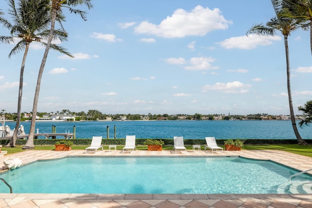 view of pool featuring a water view and a patio area