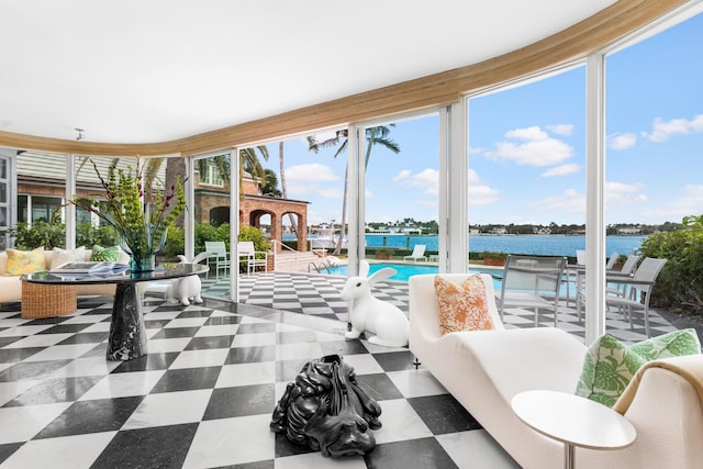 sunroom / solarium with a water view