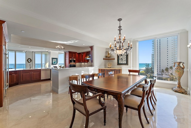 dining area with a water view, ornamental molding, and a healthy amount of sunlight