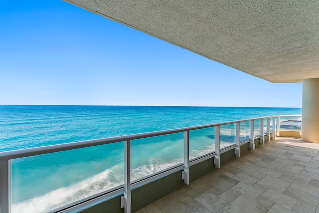 balcony with a beach view and a water view