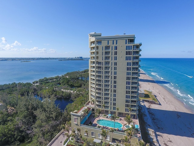 birds eye view of property featuring a view of the beach and a water view