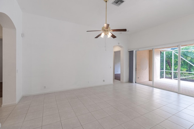 spare room with ceiling fan and light tile patterned floors