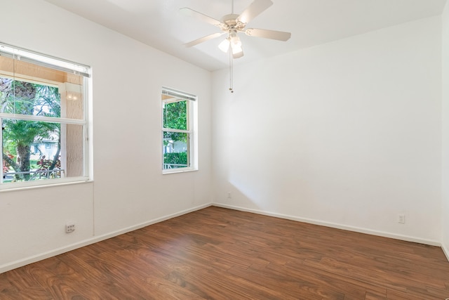 spare room featuring ceiling fan and dark hardwood / wood-style flooring