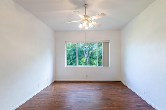 spare room with dark hardwood / wood-style floors and ceiling fan