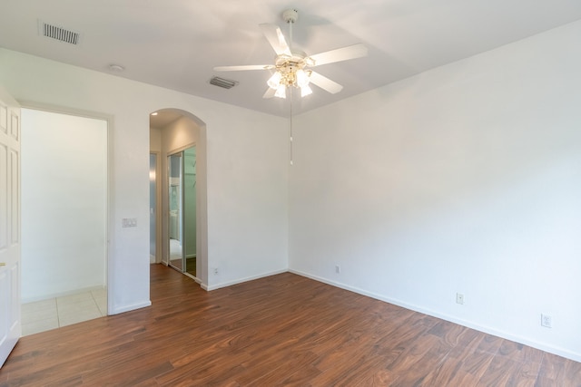 spare room featuring dark wood-type flooring and ceiling fan