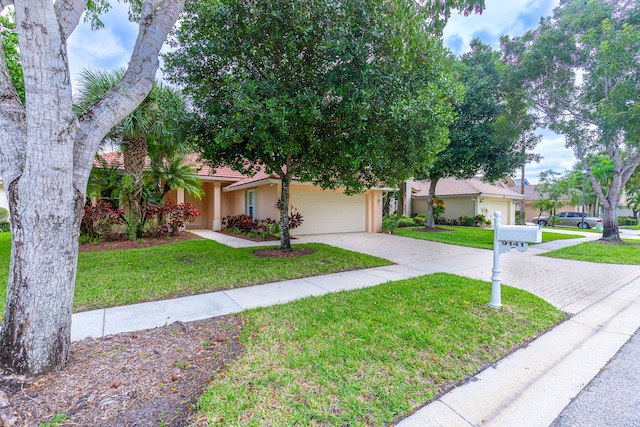 view of front of house with a garage and a front lawn