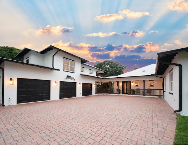 view of front of house featuring a porch and a garage