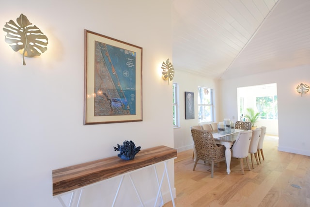 dining area with vaulted ceiling, wood ceiling, and light hardwood / wood-style flooring