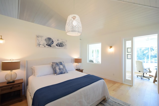 bedroom with vaulted ceiling with beams, light hardwood / wood-style flooring, and wooden ceiling