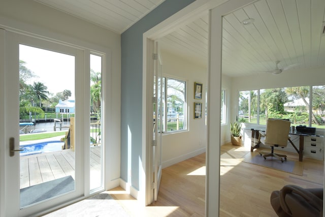 doorway to outside with wood ceiling and light hardwood / wood-style flooring