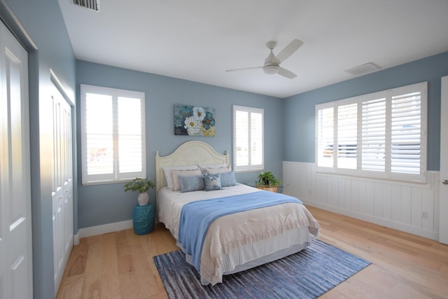 bedroom featuring ceiling fan, a closet, and light hardwood / wood-style flooring