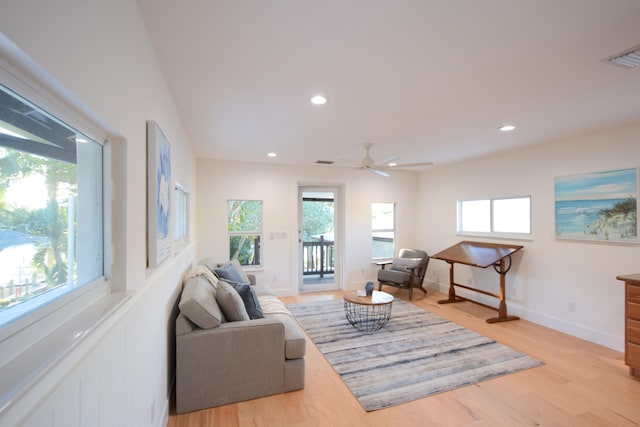 living room featuring plenty of natural light, light hardwood / wood-style floors, and ceiling fan