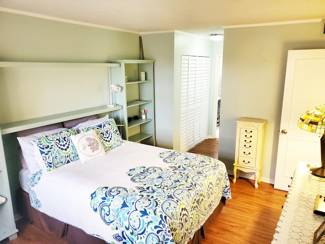 bedroom featuring wood-type flooring and ornamental molding