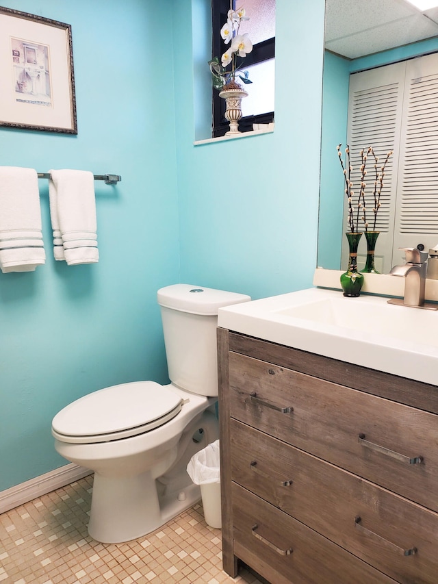 bathroom with tile patterned flooring, vanity, and toilet