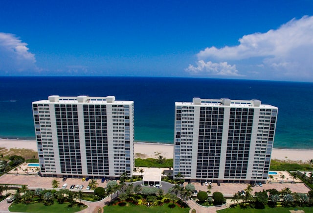 drone / aerial view featuring a water view and a beach view