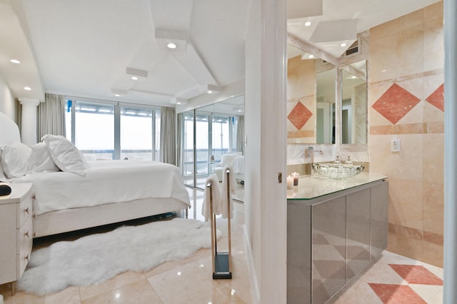 bedroom with ornate columns and sink