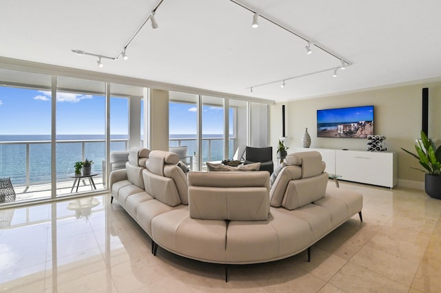 living room featuring track lighting, light tile patterned floors, and expansive windows