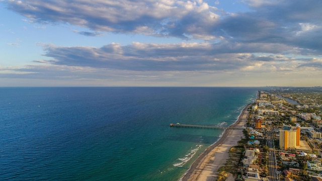 bird's eye view featuring a water view and a beach view