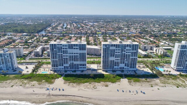 drone / aerial view featuring a beach view and a water view