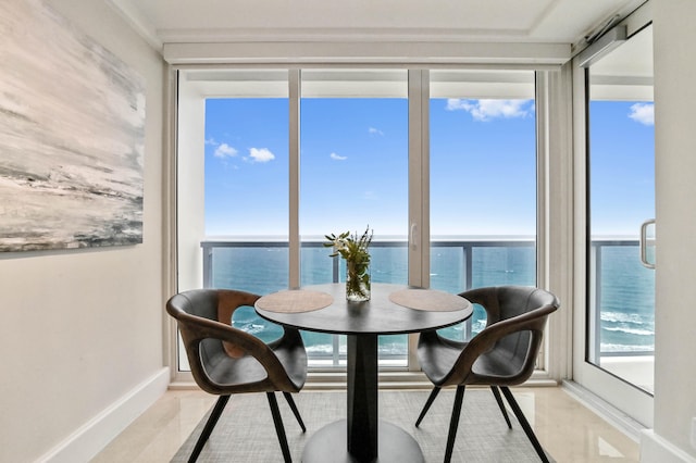 sunroom / solarium featuring a water view