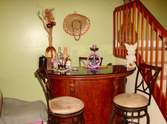 bar featuring a dry bar and stairway