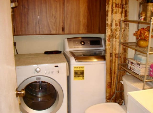 clothes washing area with washer and clothes dryer