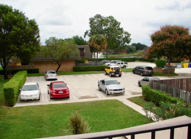 view of parking / parking lot with a yard