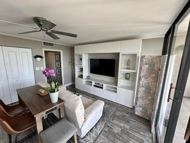 living room with ceiling fan, dark hardwood / wood-style floors, and ornamental molding