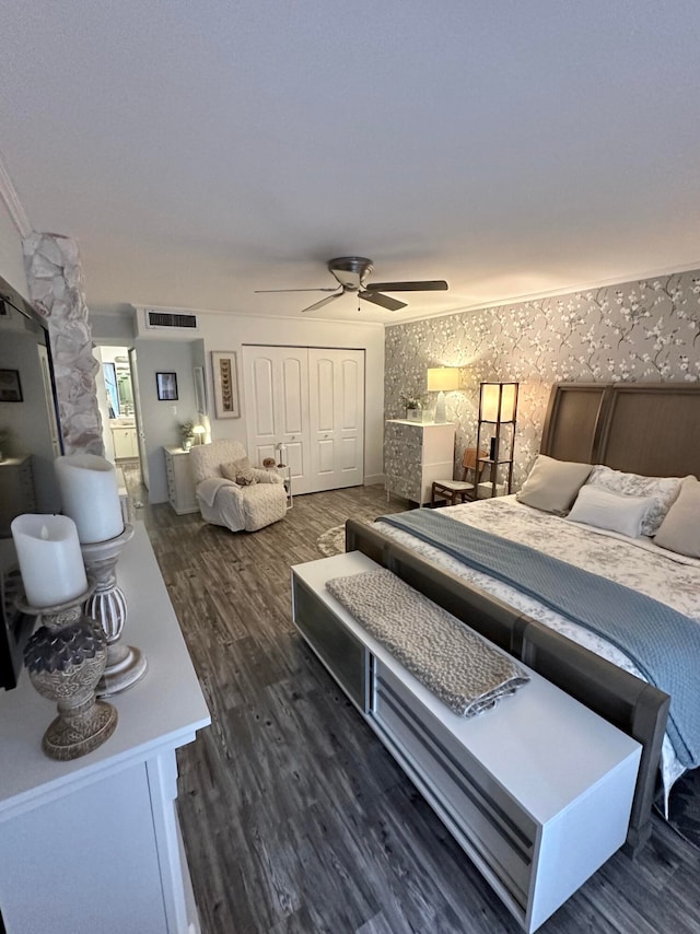 bedroom with a closet, dark hardwood / wood-style floors, and ceiling fan